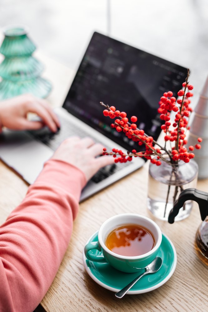 Red,Tea,And,Man,Working,At,His,Laptop,In,Cafe,
